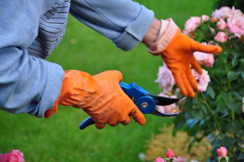 Security badge and gardener taking payment on tablet